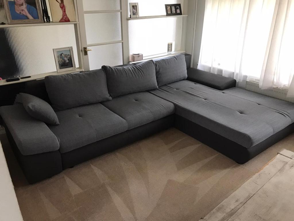 This is a photo of a grey L shape sofa that has been professionally steam cleaned, also the beige carpets have been steam cleaned too carried out by Blackheath Carpet Cleaning.