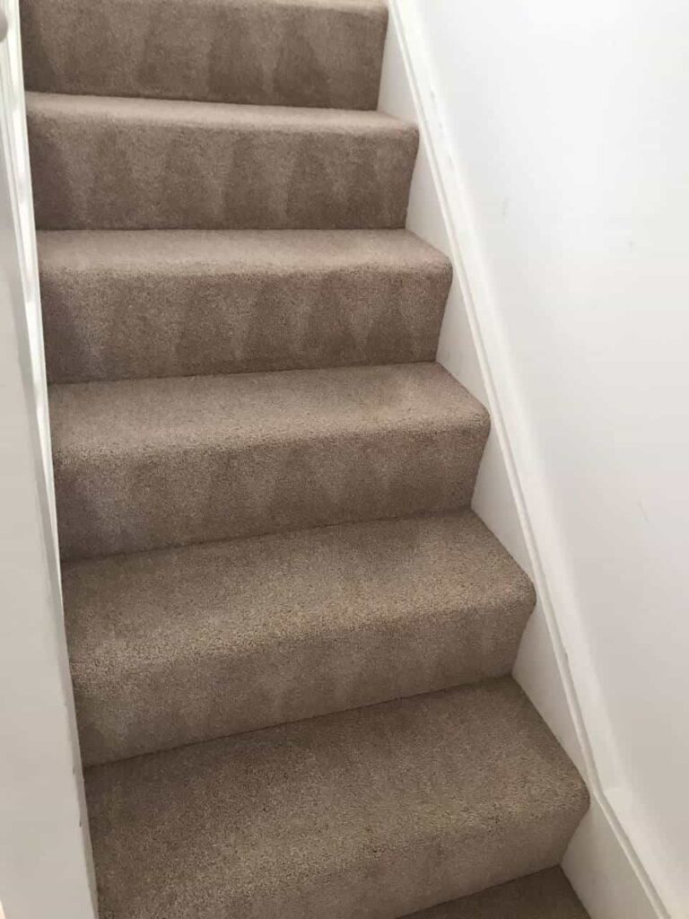 This is an after photo of a staircase with a beige carpet that has been cleaned carried out by Blackheath Carpet Cleaning.