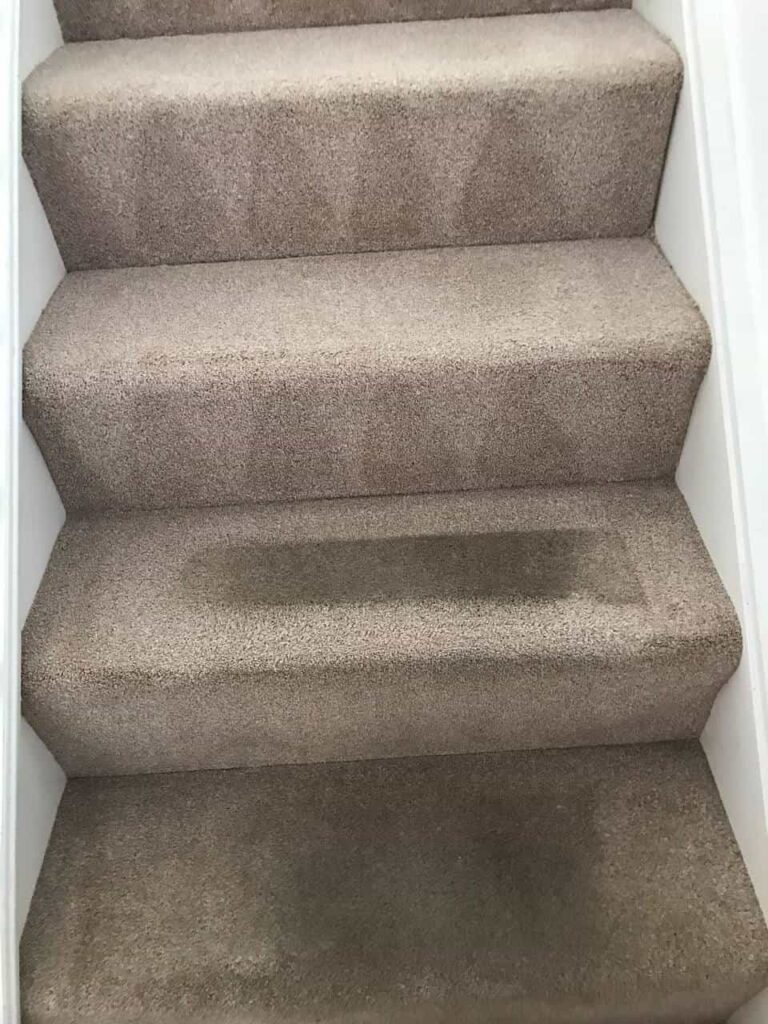this is a photo of a staircase with beige carpets that is in the process of being cleaned carried out by Blackheath Carpet Cleaning.