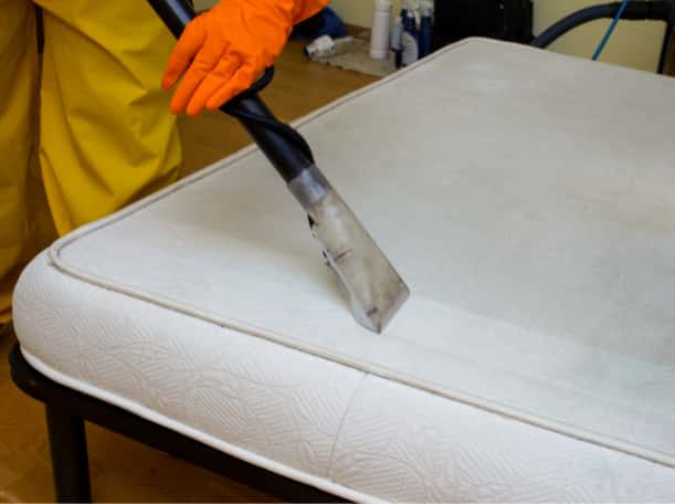 This is a photo of a man steam cleaning a dirty mattress carried out by Blackheath Carpet Cleaning.